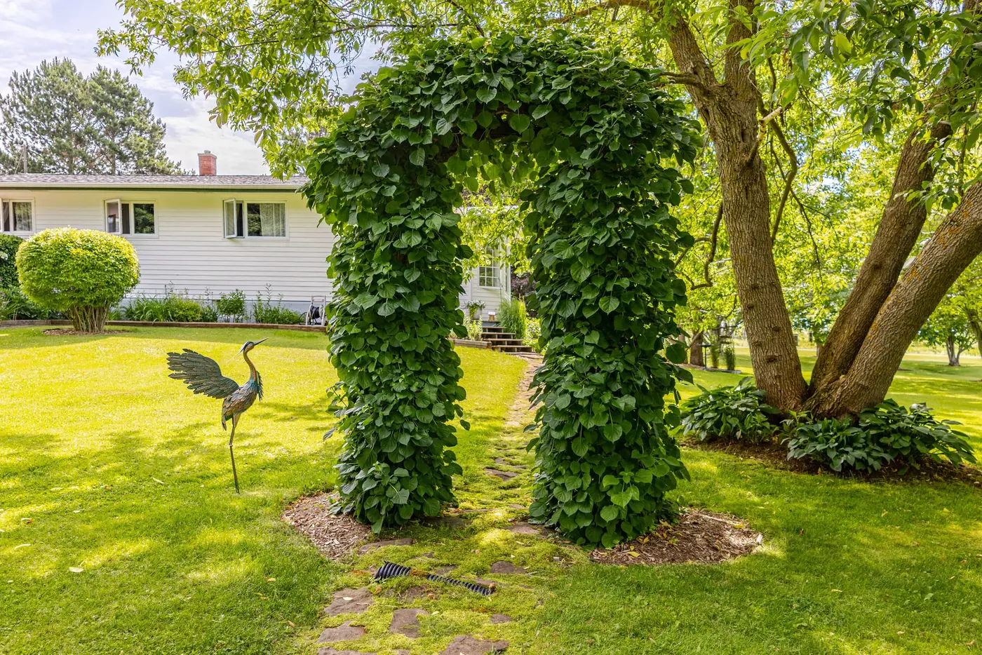 The garden arch and the heron sculpture at Heron's Nest Sanctuary